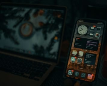 a cell phone next to a laptop